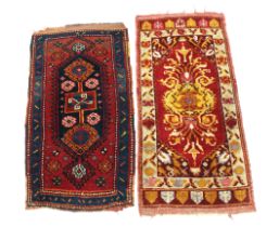 Two small hand knotted wool rugs, 121 x 53 cm and 110 x 54 cm.