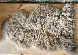 A sheepskin rug by Hanlin - in very good condition, with comb.