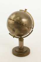 A 1950s retro brass and plated globe cigarette dispenser - the globe on a circular stand, the oceans