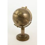 A 1950s retro brass and plated globe cigarette dispenser - the globe on a circular stand, the oceans