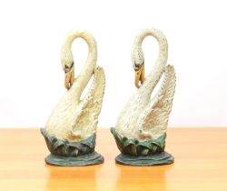 A pair of reproduction cast iron swan doorstops