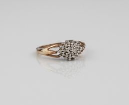 A 9ct gold and diamond cluster ring - set with small brilliant cut diamonds in an elliptical