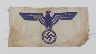 A WWII German blue woven Kriegsmarine Bevo breast eagle on white cloth.