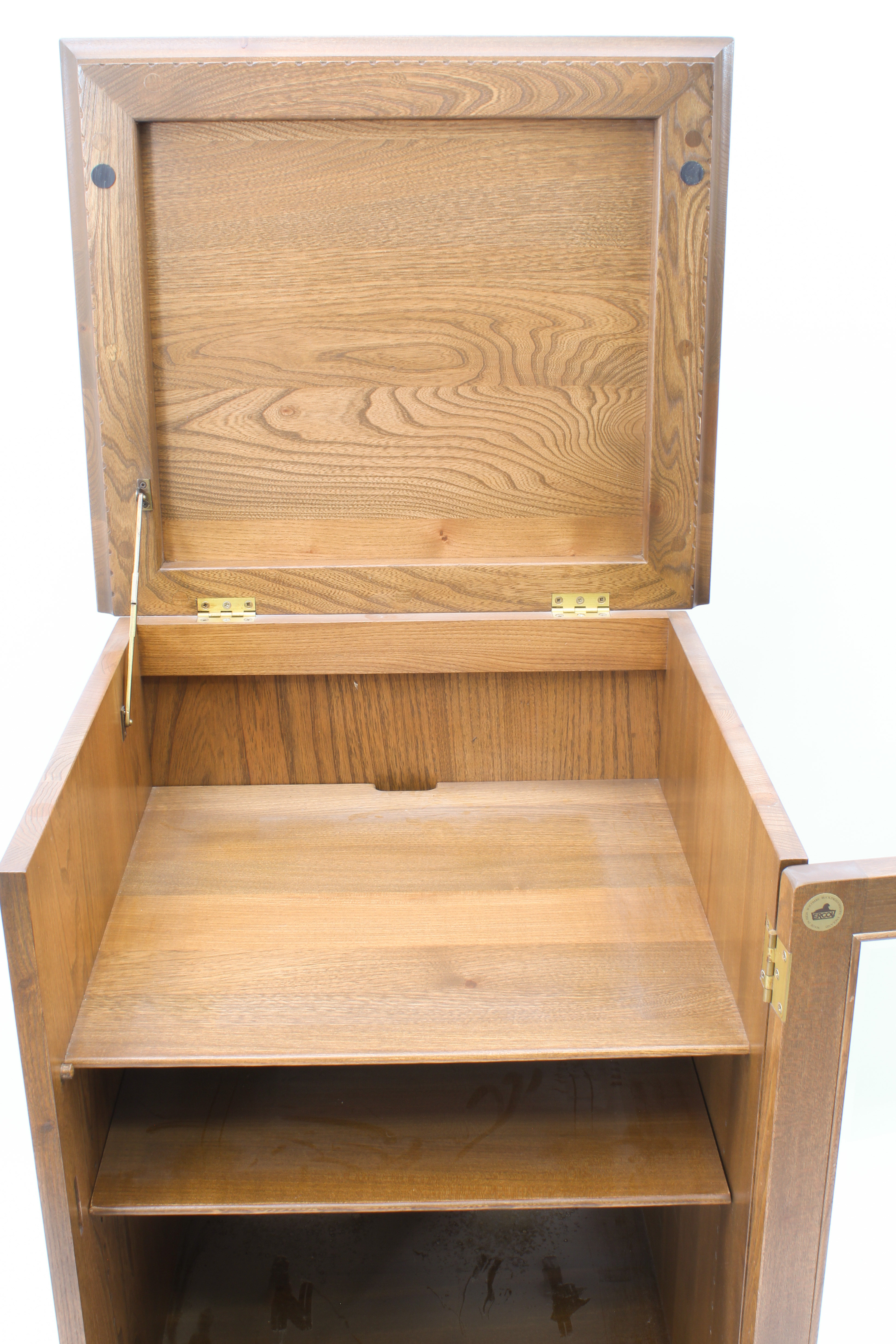 An Ercol elm hi-fi cabinet - with dentil frieze over a glazed door enclosing two shelves, above a - Image 6 of 13
