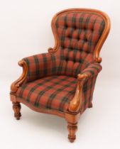 A Victorian-style carved walnut showframe armchair in tartan upholstery - the buttoned spoon back