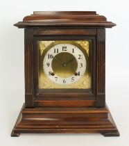 A 1920s walnut cased chiming mantel clock - the eight day, half hour striking movement fronted by