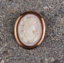 An antique 9ct rose gold and shell cameo brooch - oval, marked '9CT', carved with the bust of a