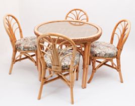 A circular cane conservatory table and four chairs - the table 98 cm diameter, 76 cm high, the