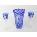 A pair of blue cased cut glass wine glasses, probably by Val St Lambert - the ogee bowls with blaze,