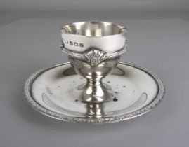 A George V silver egg cup - F. C. Richards, Birmingham 1930, the cup with decorative girdle on a
