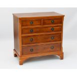 A reproduction Georgian style yew veneered chest of drawers - of small proportions, the cross-banded