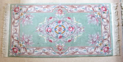 A Chinese floral wool rug - late 20th century, with a large floral medallion and spandrels on a