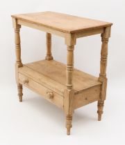 A Victorian two-tier stripped pine side table - the rectangular top raised on turned supports,