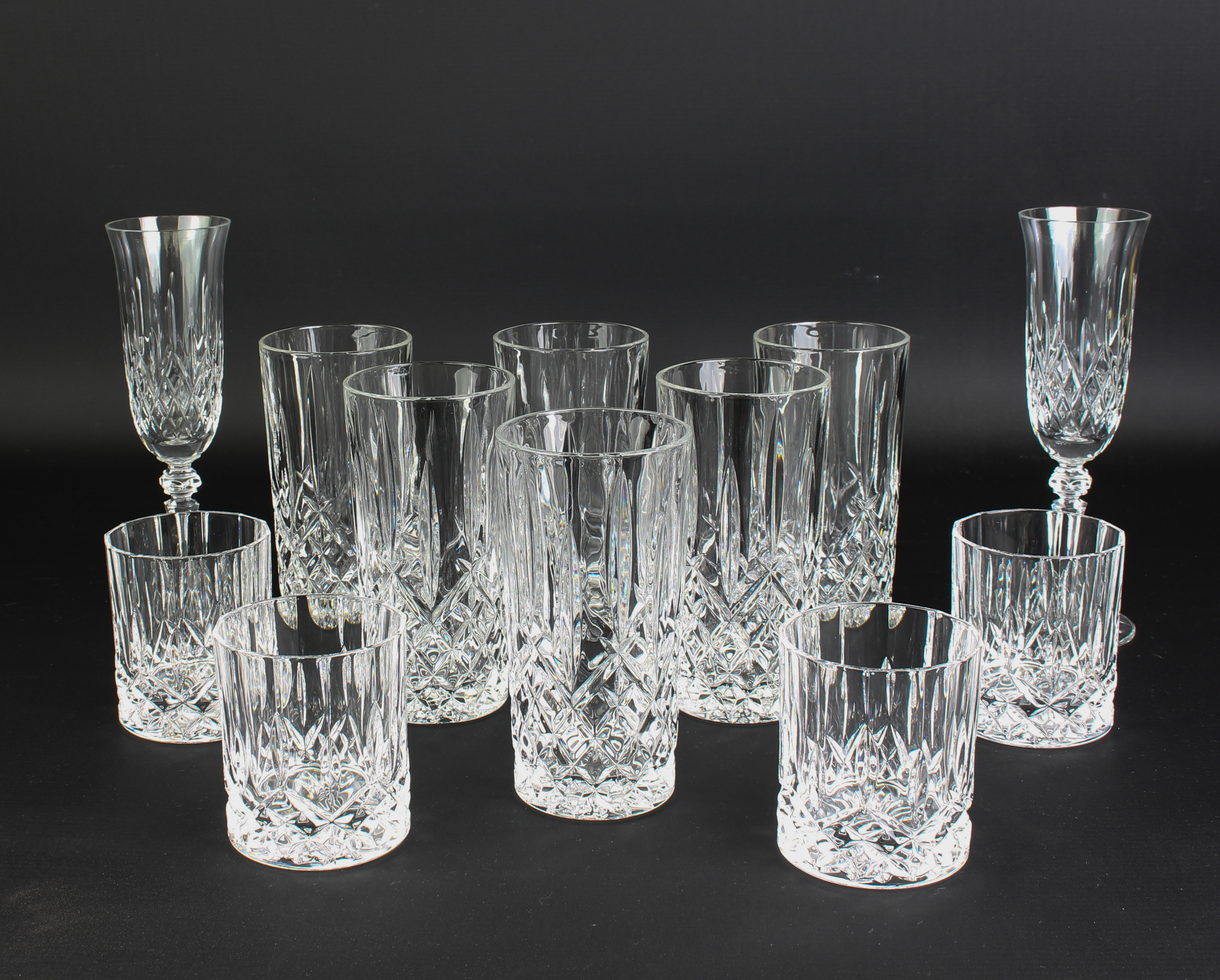 A pair of Galway cut glass champagne flutes - etched factory mark, 20.6 cm high; together with a set