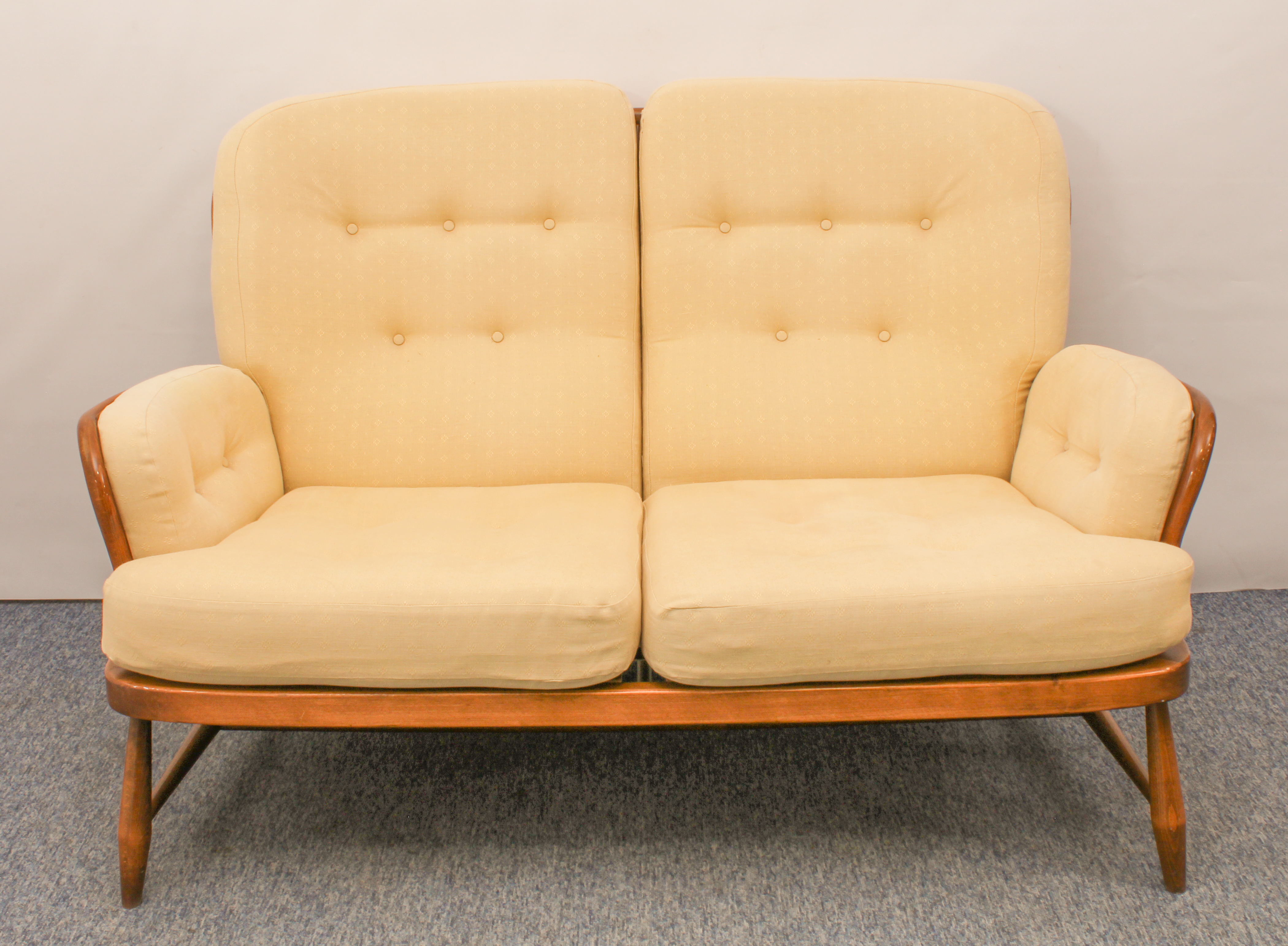 An Ercol Windsor beech and elm two-seater sofa - Jubilee model, no.766, with original pale gold