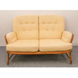 An Ercol Windsor beech and elm two-seater sofa - Jubilee model, no.766, with original pale gold