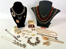 A collection of silver and costume jewellery - including an amber bead necklace; a silver charm