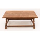 An antique style oak coffee table - mid-20th century, the rectangular top on four splayed,