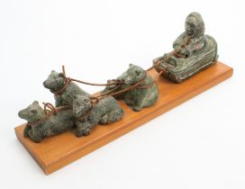 An Inuit sculpture of a dog-drawn sledge by Wolf Sculptures of Canada - the resin sculpture
