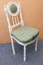 A French painted bedroom chair: the off-white painted frame with padded bullseye back within