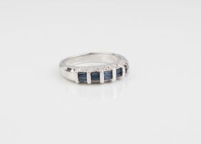 A 14ct white gold, blue sapphire and diamond ring - Birmingham hallmarks, the five pairs of baguette