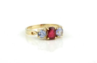 A 14ct yellow gold, ruby and pale mauve stone ring - unmarked, tests as 14ct gold, the central