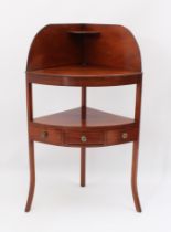 An early 19th century mahogany bowfront two-tier corner washstand - the later fixed top with