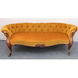 A mid-19th century carved walnut showframe low Chesterfield settee - upholstered in mustard-gold