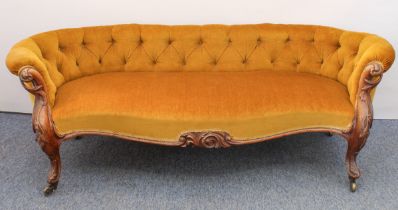 A mid-19th century carved walnut showframe low Chesterfield settee - upholstered in mustard-gold