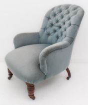 A Victorian button-back tub armchair - upholstered in blue velour, on turned mahogany front legs