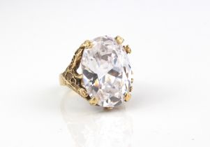 A 9ct gold ring set with a large rock crystal - the oval cut rock crystal, approx. 21.5 x 16mm, in a