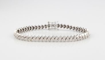 An 18ct white gold and diamond-set bracelet - stamped 750, the chevron links set with trios of