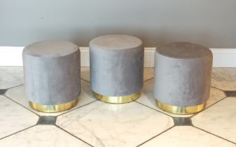 A set of three drum-form stools - modern, upholstered in light-grey, on gilt bases, 38 cm