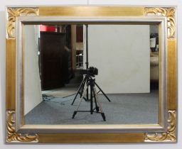 A gilt and silvered rectangular mirror - late 20th century, the moulded frame with foliate