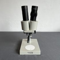 A Philip Harris binocular student microscope - with W10X/20 lenses, 26 cm high.