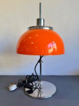 A retro 1970s orange acrylic and chrome table lamp - with domed shade and plain column to a circular