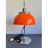 A retro 1970s orange acrylic and chrome table lamp - with domed shade and plain column to a circular