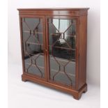 An Edwardian inlaid mahogany display cabinet or glazed bookcase - the satinwood banded top over a