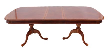 A reproduction 19th century style crossbanded mahogany and marquetry extending two-pedestal dining