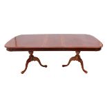 A reproduction 19th century style crossbanded mahogany and marquetry extending two-pedestal dining