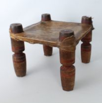 An Indian turned wooden and vellum stool - early to mid-20th century, square, the vellum seat