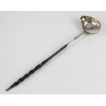 A 19th century white-metal toddy ladle - no marks, the oval bowl with side spout and engraved