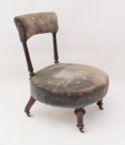 A Victorian walnut nursing chair - the padded top back on fluted turned uprights, over a circular