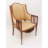 An Edwardian mahogany and satinwood open armchair in the Sheraton revival taste - the angular back