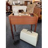 A vintage 1970s Singer 368 Fashion Mate electric sewing machine - fitted into a teak table