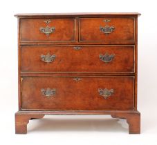 A reproduction Georgian-style burr walnut and yew chest of drawers - late 20th century, of small