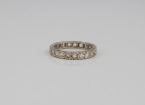 A 9ct white gold full eternity ring - hallmarked London 2004, with 21 round cut white stones, size