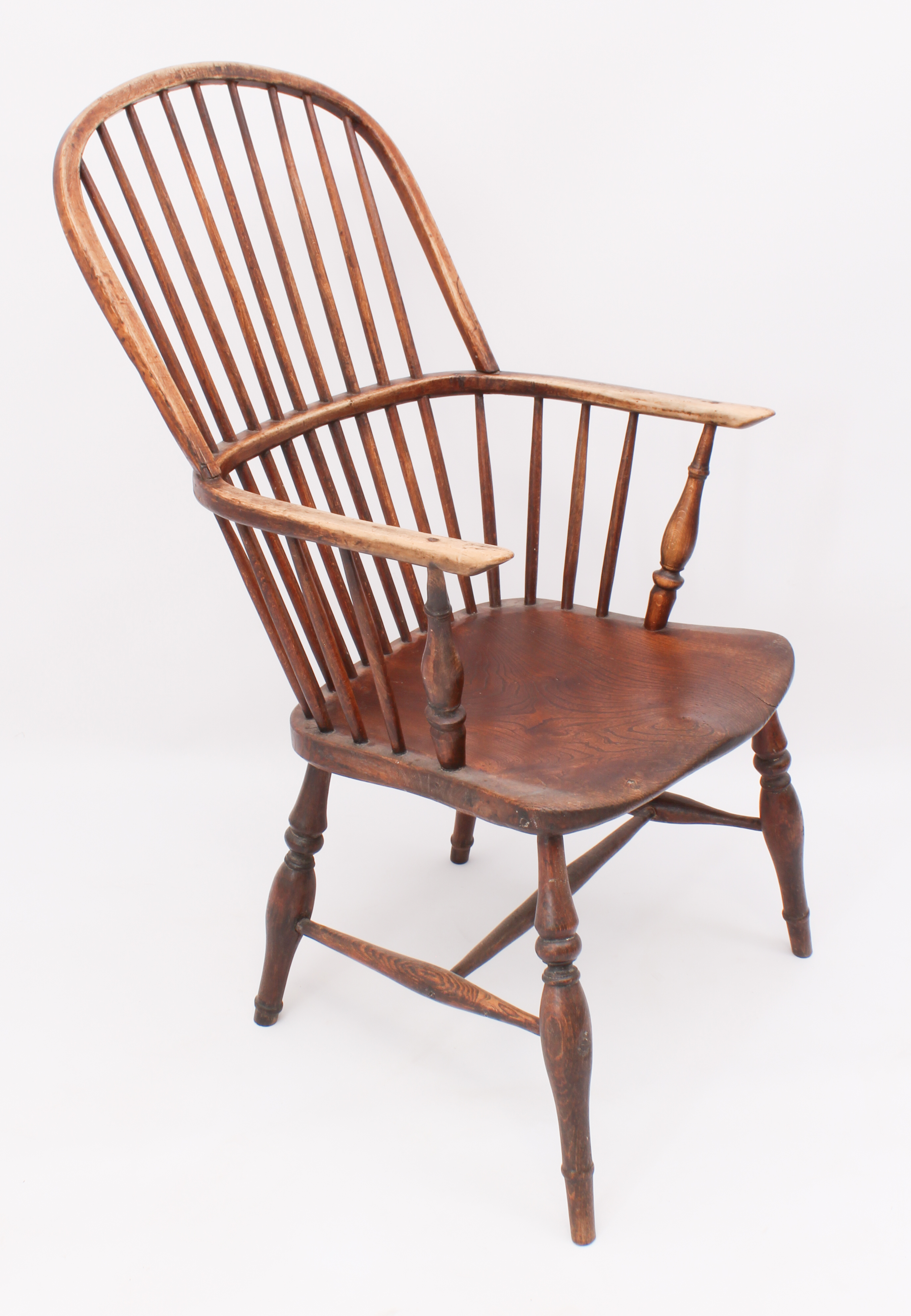 An early 19th century beech and elm hoop back Windsor arm chair - the D-shaped stick back over