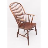 An early 19th century beech and elm hoop back Windsor arm chair - the D-shaped stick back over