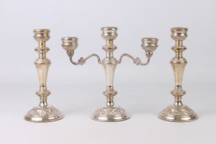 A three piece Elizabeth II silver candelabra and candlestick set - W I Broadway & Co., Birmingham